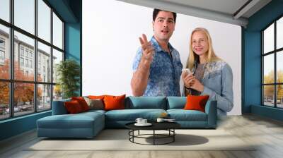 Young Persian man and beautiful blond woman against white backgr Wall mural