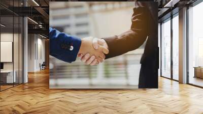 Close up at handshake Businessman is holding cooperation together, it is a promise to invest in doing business together. Become a partner to provide information. Modern marketing planning techniques. Wall mural