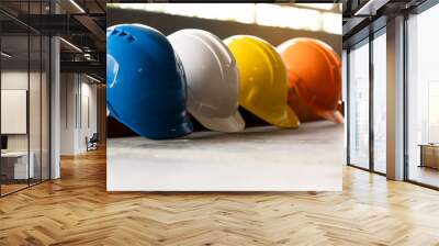 Safety Construction Worker Hats Blue, white, yellow, orange. Teamwork of construction team must have quality. Whether it engineer, construction workers. Have a helmet to wear at work. Safety at work. Wall mural