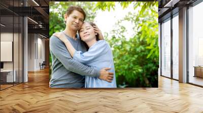 Senior Asian Women and men Standing in garden during summer Which is lover who has been caring for long time Take care of health And travel together in retirement Concepcion insured the elderly Wall mural