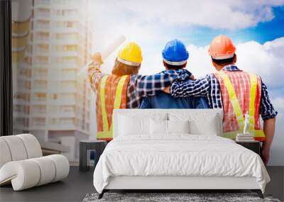 Team Construction asian workers are both engineers and builders are proud to succeed in the design and construction of buildings for Foreign customers. Good teamwork concept. Wall mural