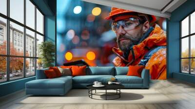 Worker in hard hat and safety glasses using tablet in factory Wall mural