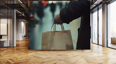 A person carrying shopping bags on a bustling street adorned with festive holiday lights, capturing the joyful Christmas spirit. Wall mural