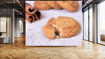 round oatmeal cookies with crumbs on a white table Wall mural