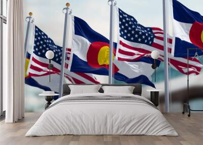 Colorado and US flags waving in the wind on a clear day Wall mural