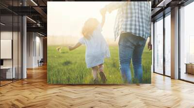 father and child walking on sunset Wall mural