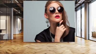 Portrait of fashioned woman in stylish sunglasses Wall mural