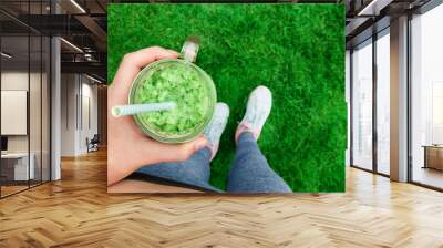 Young girl drinking fruit smoothie . Fitness and healthy lifestyle concept. Wall mural