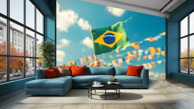 Hand holding Brazil national flag on blue sky. Happy Independence Day, Labor Day, Proclamation of the Republic. Background with copy space for greeting card, banner, poster Wall mural