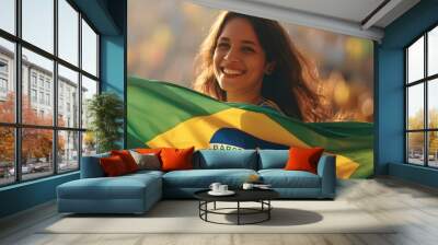 Happy young girl football fan celebrating her team victory. Latino woman with Brazil flag laughing and smiling. Celebration of Independence Day, Labor Day, Proclamation of the Republic Wall mural