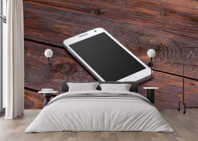 smart phone with blank screen lying on wooden table Wall mural