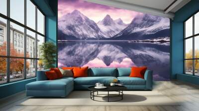 Snow morning at mountain lake. Snowy mountains, blue sea, reflection in water and purple sky at colorful sunset. Ideal resting place. Beauty of nature concept background Wall mural