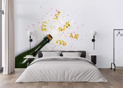 White background with champagne bottle with confetti and party streamers. Christmas, birthday, party or wedding banner concept. Flay lay copy space Wall mural