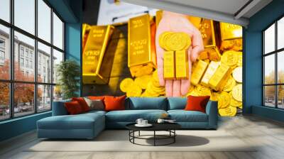 Businessman in suit sits at his desk, holding a shining gold bar. financial charts, the scene symbolizes wealth, investment success, growing influence of cryptocurrency and blockchain. Wall mural