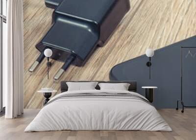 Black smartphone and charger using to charge empty battery. Various devices charging concept Wall mural