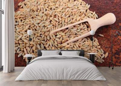 Heap of rye grain with wooden spoon Wall mural