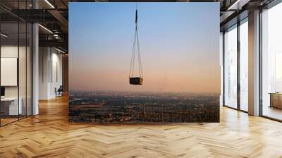 07-01-2020, Bangkok, Thailand. Workers are constructing high-rise building by pouring it onto the steel that has already been prepared on the rooftop beside the Chao Phraya River at the sunset time Wall mural