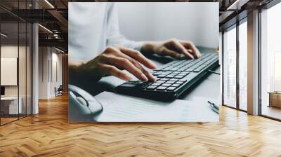 2 hands of Asian woman is press, typing on 2 language keyboard as Thai and English. Maybe preparation about information to report, chat to lover or shopping online by connect to internet at home, cafe Wall mural