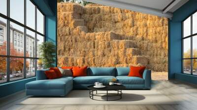 A pile of hay is stacked in a pyramid shape Wall mural