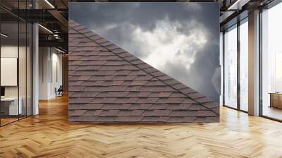 brown roof shingle on cloudy day in rainy season. Wall mural