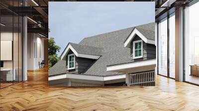 Roof shingles with garret house on top of the house. dark asphalt tiles on the roof background on afternoon time. dark asphalt tiles on the roof background Wall mural