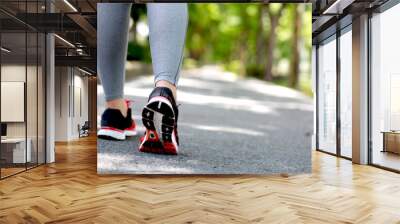 A woman is walking at the park Wall mural