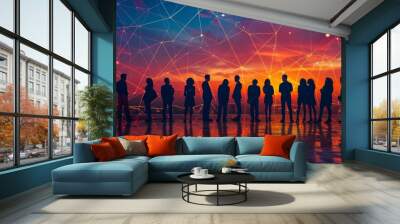 A group of people are standing in a line, with the sun setting in the background. Concept of unity and togetherness, as the people are all standing side by side. The sunset adds a warm Wall mural