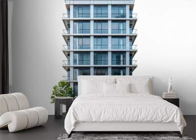 A tall building with a lot of windows and a green tree in front of it Wall mural