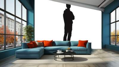 black silhouette of a man standing with crossed arms. It looks like a secret agent. Wall mural