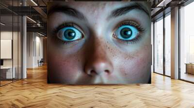 A close-up of a young woman's eyes, illuminated by the blue glow of a screen in a darkened room, conveys a sense of heightened energy and euphoria. Wall mural