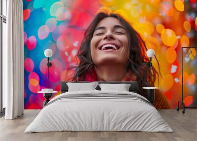 A joyful woman laughing with her eyes closed against an abstract background, surrounded by colorful bokeh lights Wall mural