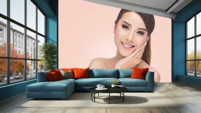 Beautiful woman cares for the skin face, Beautiful Spa Woman Touching her Face, Perfect Fresh Skin posing at studio on pink background with clipping path.  Wall mural