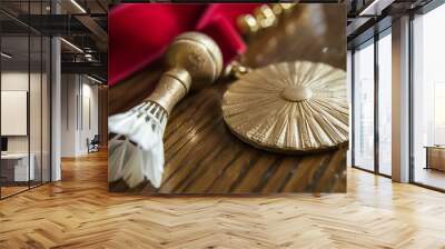 Golden badminton medal and shuttlecock on wooden surface with red ribbon. Wall mural