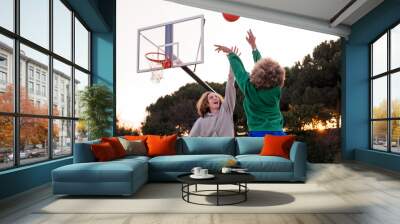 couple of friends playing basketball outdoors Wall mural