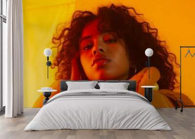 Woman With Curly Hair Wearing a Yellow Jacket Wall mural