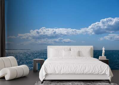 Blue sea and sky background, blue shades and white clouds. Wall mural