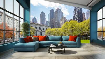 Bryant park, New York, Manhattan. High buildings view from below against blue sky background, sunny day in spring Wall mural