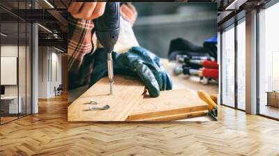 Carpenter working with an electric screwdriver Wall mural