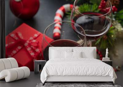 Christmas red wine glasses and xmas decoration on the table, closeup view Wall mural