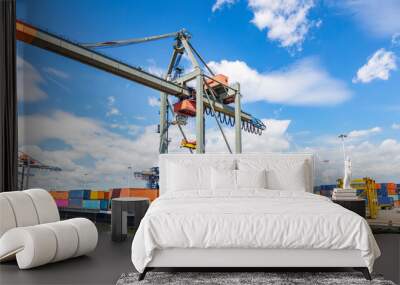 Container ship and logistics. Crane loading a container ship at Rotterdam port Wall mural