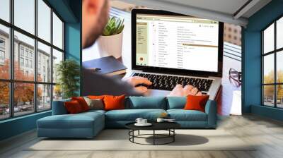 Emails list on a laptop screen, office workspace Wall mural