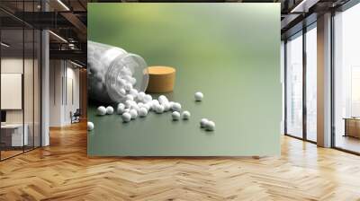 Glass container and homeopathic pills on blur green nature background. 3d illustration Wall mural