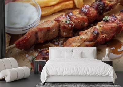 Grilled meat skewers on a table, closeup view Wall mural