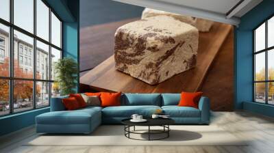 Halva cocoa pieces on wooden table background, closeup view. Wall mural