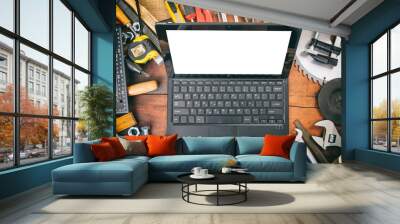 Hand tools and laptop on wooden background Wall mural