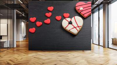 Heart shaped biscuits on a black background Wall mural