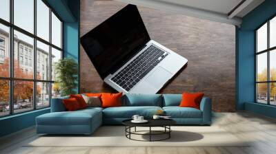 Laptop with black blank screen on a wooden desk Wall mural