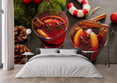 Mulled wine, Christmas hot drink in cups on black stone, closeup view Wall mural