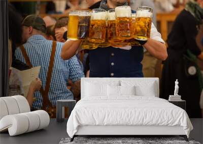 Oktoberfest, Munich, Germany. Waiter serve beer, closeup view. People in traditional Bavarian costume  Wall mural