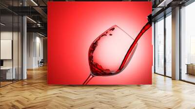 Red wine pouring. Wine bottle pouring red wine in a crystal goblet closeup view. 3d illustration Wall mural